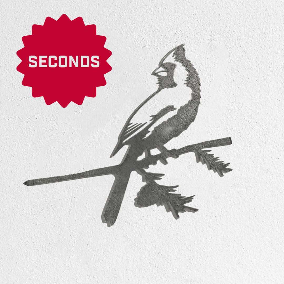 Metalbird Seconds by Metalbird Canada - Seconds features a bird silhouette perched on a branch, displayed against a white wall. A red starburst labeled SECONDS in the top left corner adds bold flair to this garden art-inspired decor.