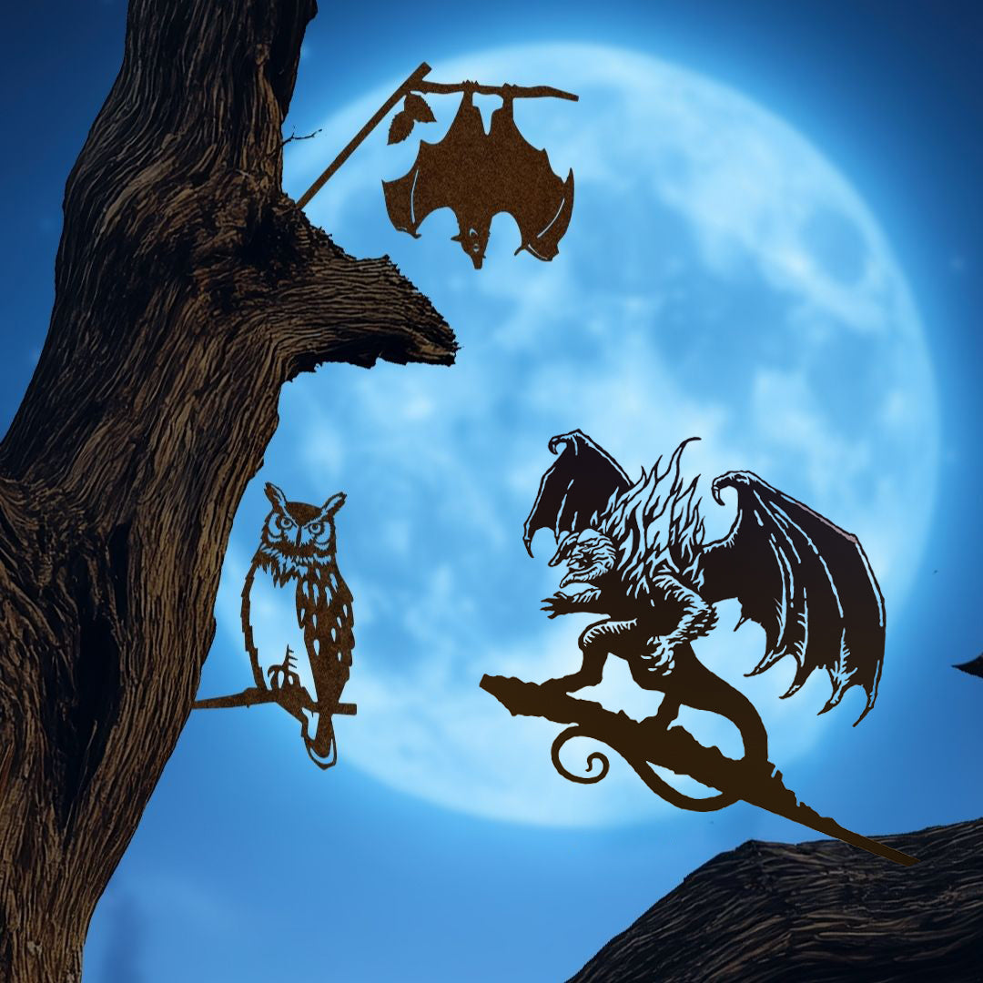 The Boo-tiful Bundle 🎃 by Metalbird Canada features owl, bat, and dragon silhouettes on branches against a full moon—striking Halloween yard art and perfect corten steel sculptures for your outdoor space.