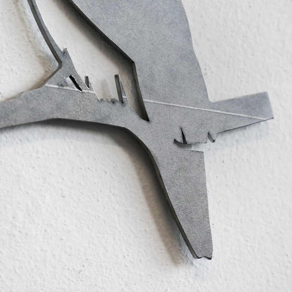 Close-up of Metalbird Seconds by Metalbird Canada - Seconds, a minimalist metal wall art featuring a bird silhouette on a branch with clean lines and matte gray finish—ideal as unique garden art or a thoughtful gift.