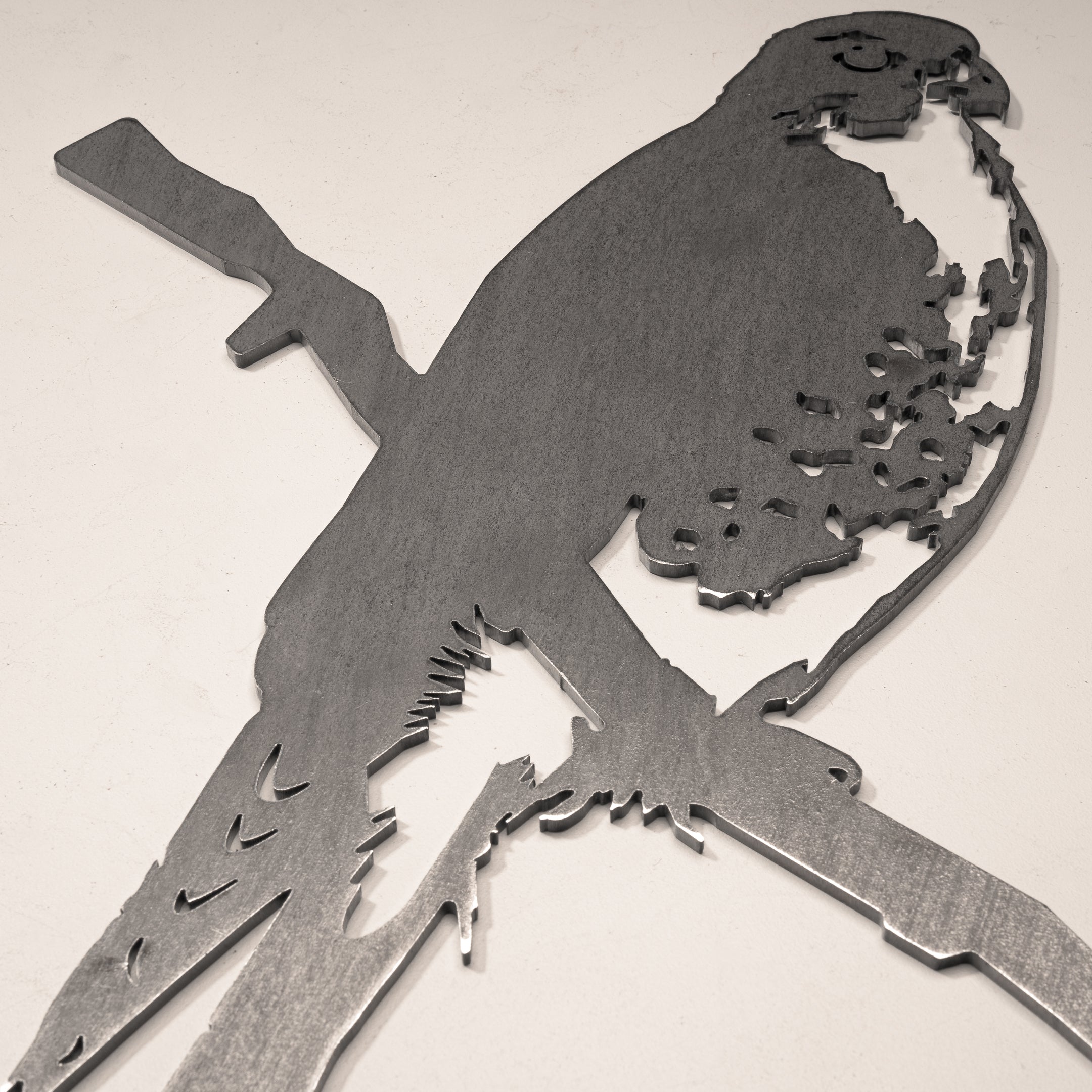 The Peregrine Falcon by Metalbird Canada is a detailed metal cutout sculpture of a falcon on a branch, adding striking garden art and making a unique gift for nature lovers.