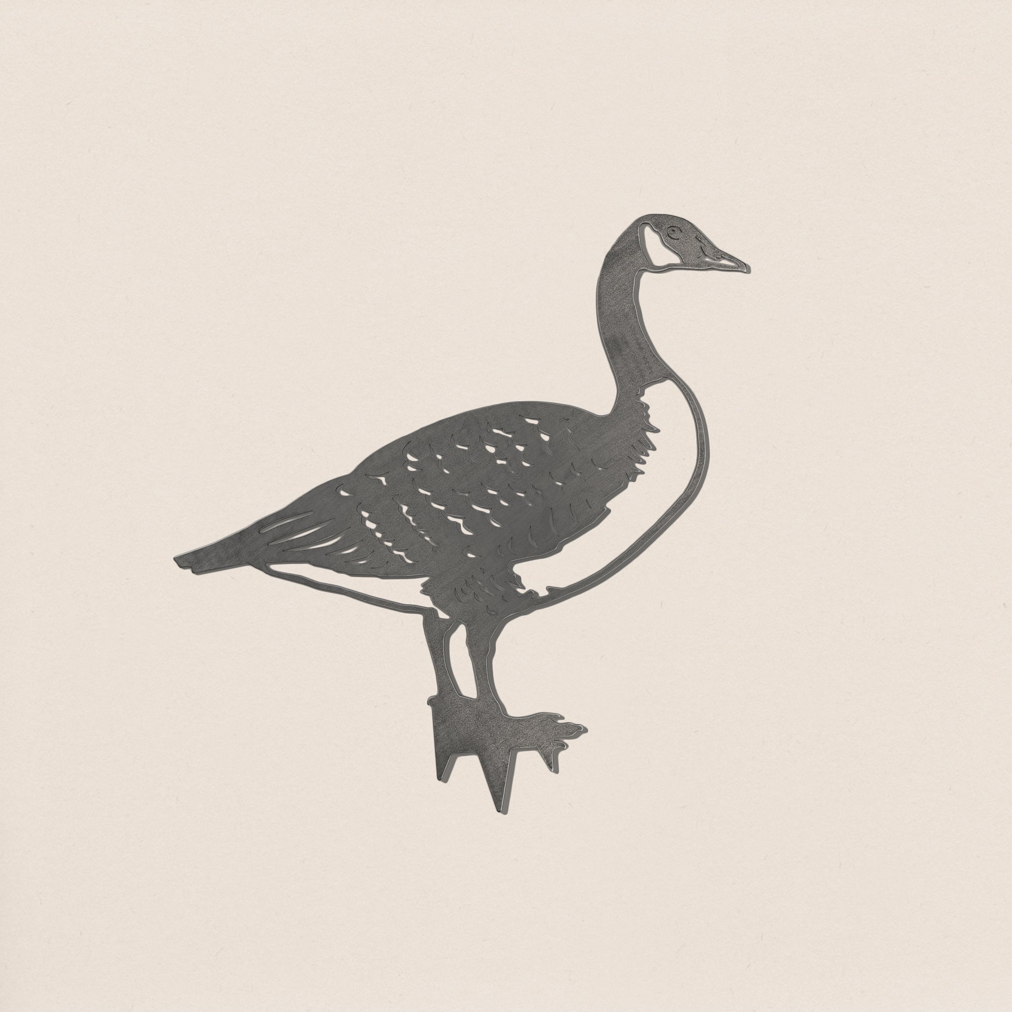 The Canada Goose by Metalbird Canada is a black and white profile illustration of a goose standing on one leg, with feather details and simple outlines, creating a graceful garden art silhouette against a light background.
