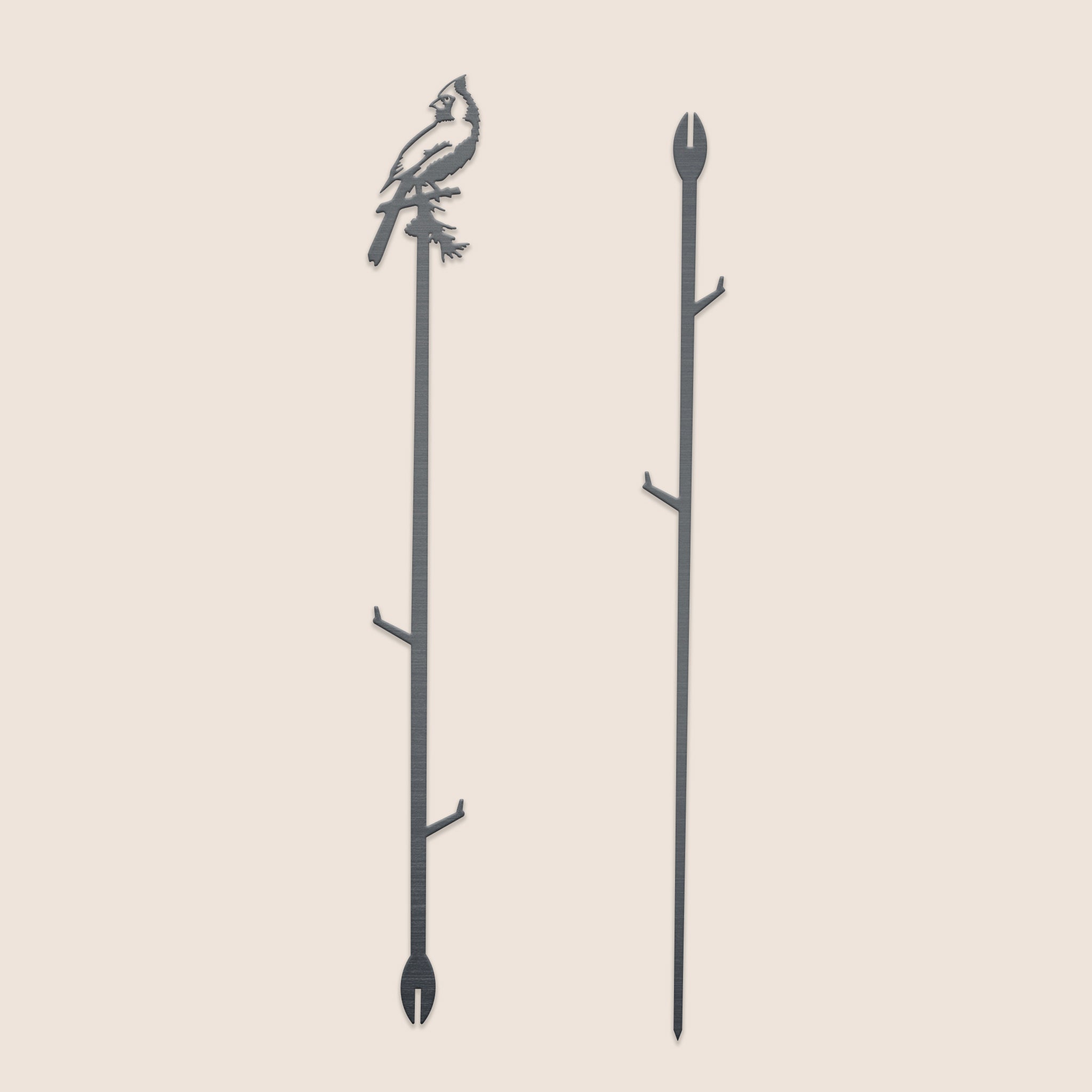 The Metalbird Canada Cardinal Plant Stake - 40" is a black corten steel garden stake featuring a cardinal cutout atop a branch and pointed end for easy placement—an ideal, unique garden gift.