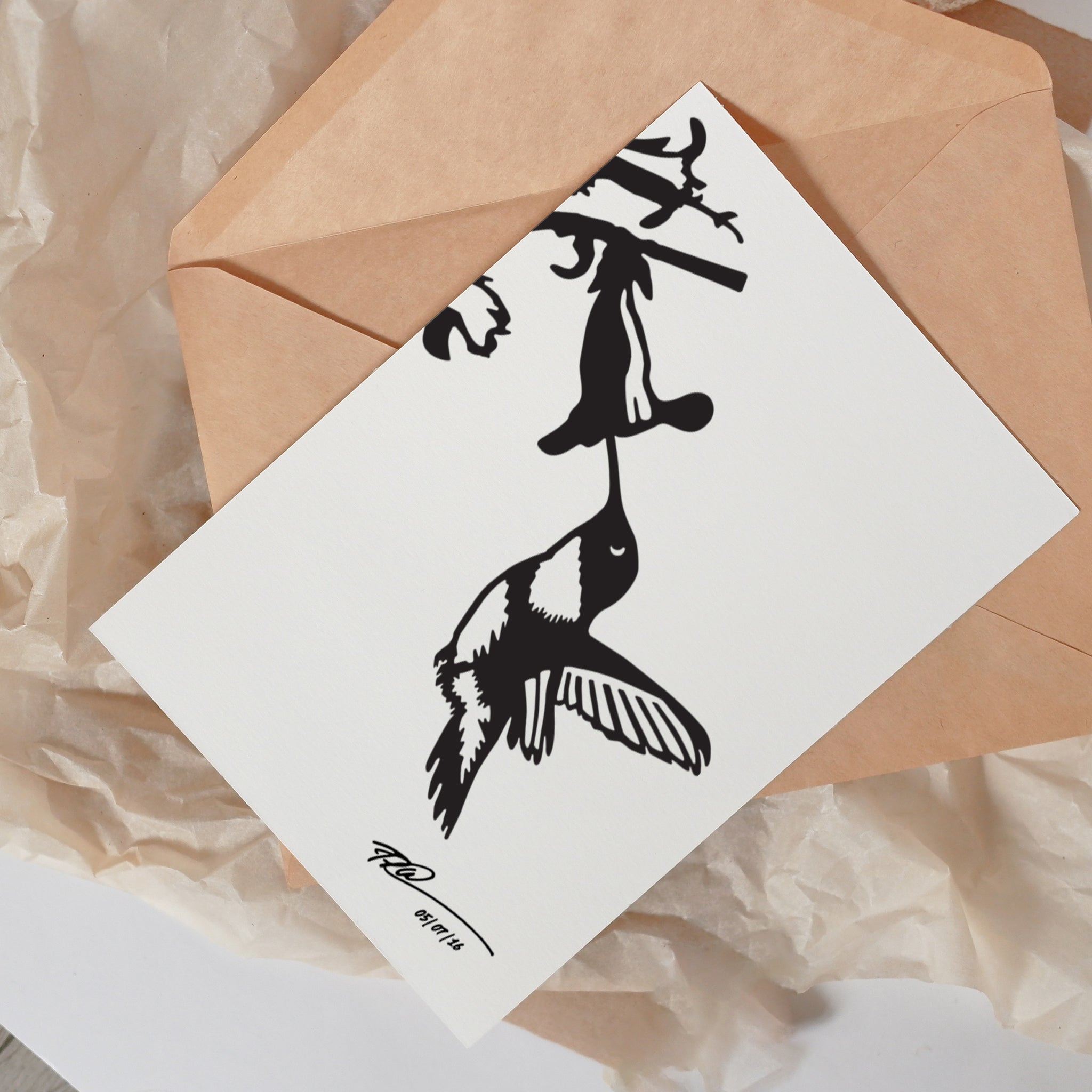 The Metalbird Greeting Card Set by Metalbird Canada features a black and white hummingbird silhouette with floral detail, presented on a white card with a tan envelope—an ideal unique gift.