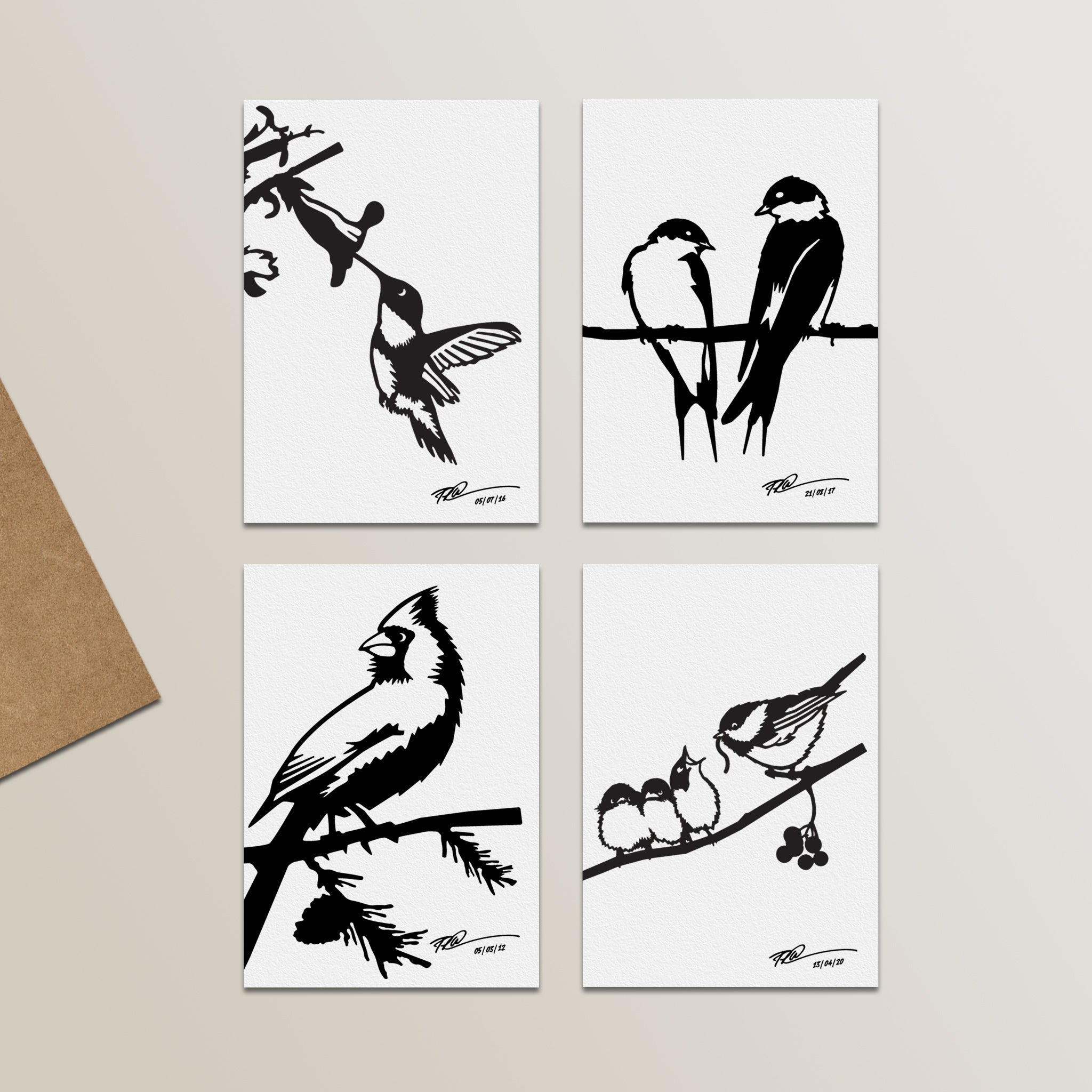 The Metalbird Greeting Card Set by Metalbird Canada features four minimalist black and white bird silhouette illustrations—each on a white card with a different species perched on branches—displayed with a brown envelope.