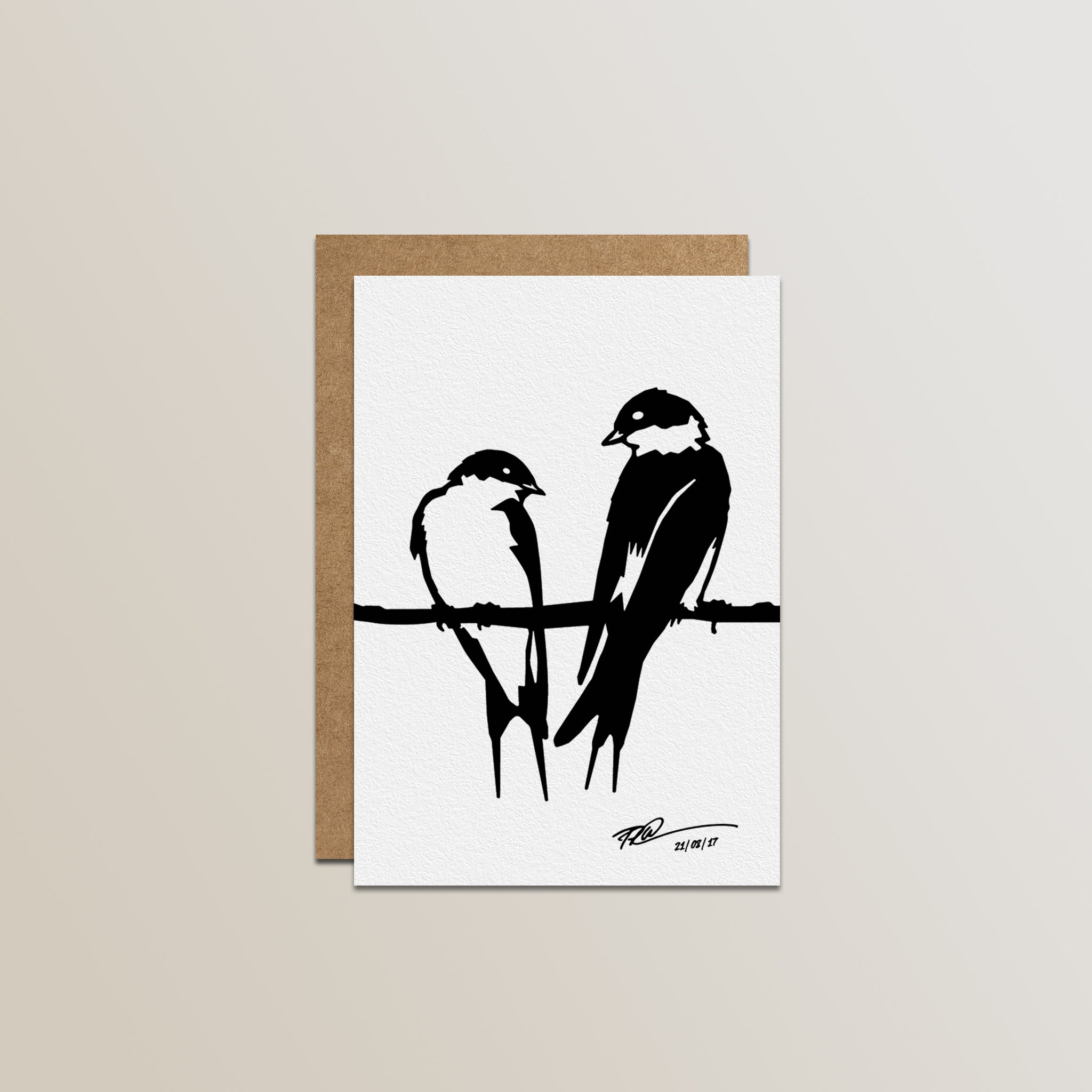 The Metalbird Greeting Card Set by Metalbird Canada features a minimalist black illustration of two swallows on a white, textured card—ideal for fans of garden art and metal designs. Includes a brown envelope, shown on a soft beige gradient background.