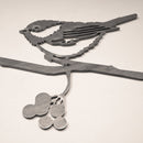 The MBPROMO Chickadee features a Corten steel bird perched on a branch with three round berries below, displayed against a plain white background.