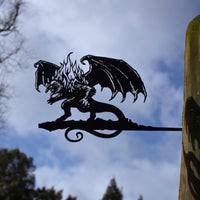 The BALROG™ by Metalbird Canada is a striking metal dragon silhouette with wings and flames, mounted on a post—an eye-catching piece of garden art for any outdoor setting.