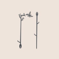 Metalbird Seconds - Plant Stake - Hummingbird by Metalbird Canada: metal hummingbird and twig designs with forked ends for soil. These seconds may have minor cosmetic flaws. Displayed on a light background.
