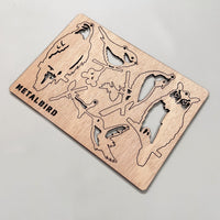 Wooden Hanging Decorations by Metalbird Canada with metal-inspired bird, owl, and butterfly silhouettes, displayed on a light gray background.