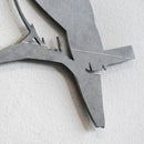 Close-up of Metalbird Seconds by Metalbird Canada - Seconds, a minimalist metal wall art featuring a bird silhouette on a branch with clean lines and matte gray finish—ideal as unique garden art or a thoughtful gift.