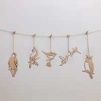 Metalbird Canada’s Wooden Hanging Decorations feature five unique bird silhouettes strung with clothespins, set against a white background. Ideal as minimalist yard art or a thoughtful gift, each bird is crafted in a delicate cut-out style.