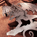 The BALROG™ by Metalbird Canada is a striking corten steel dragon cutout with outstretched wings and claws, perfect for standout garden art. It’s shown on a workbench in a workshop, with blurred tools and anvil in the background.