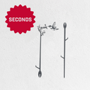 Two Metalbird Seconds garden stakes by Metalbird Canada - Seconds, each shaped like a branch with hummingbird and flower silhouettes, are shown against a white background with a red SECONDS starburst label in the top left corner.