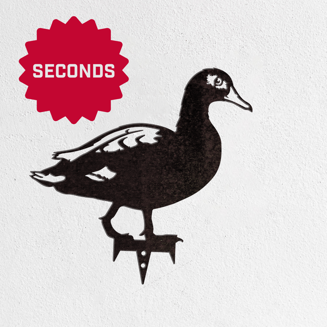 The Metalbird Seconds by Metalbird Canada - Seconds is a black metal duck silhouette on a white background, marked with a red "SECONDS" badge—ideal for garden or yard art and a delightful gift for nature lovers.