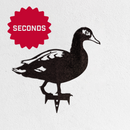 The Metalbird Seconds by Metalbird Canada - Seconds is a black metal duck silhouette on a white background, marked with a red "SECONDS" badge—ideal for garden or yard art and a delightful gift for nature lovers.