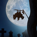 The Bat by Metalbird Canada features a corten steel silhouette of a bat hanging from a branch, set against gravestones and a full moon—ideal as spooky garden art.