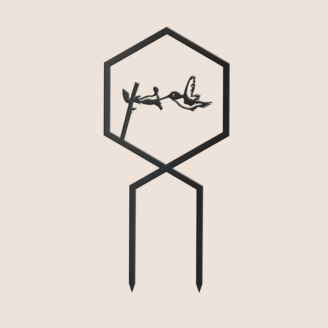 The Hummingbird Plant Trellis by Metalbird Canada is a minimalist black corten steel garden stake featuring a hexagon frame with a hummingbird silhouette near a flower, and two straight stakes for easy placement—ideal modern art for your garden.