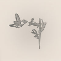 The Hummingbird by Metalbird Canada features a minimalist, monochrome design of a hummingbird feeding from a trumpet-shaped flower—ideal as metal yard art or a thoughtful gift.