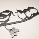 The Metalbird Canada "Chickadee & Chicks" black metal wall art features three birds on a leafy, berry-adorned branch—ideal as striking yard art or an elegant indoor accent.