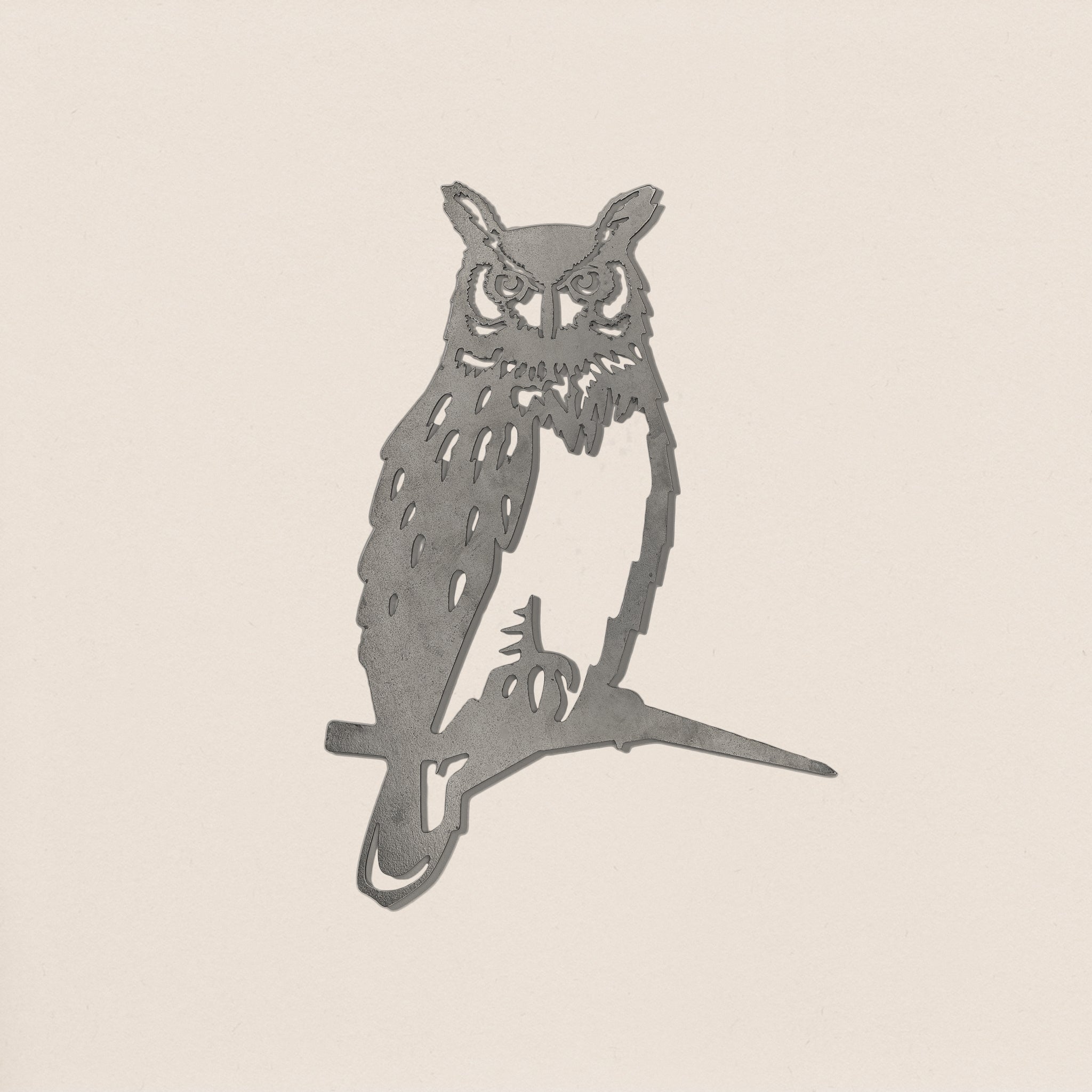 The Great Horned Owl by Metalbird Canada features a minimalist stencil design of an owl perched on a branch with simple black lines on a light beige background—ideal inspiration for metal yard art.