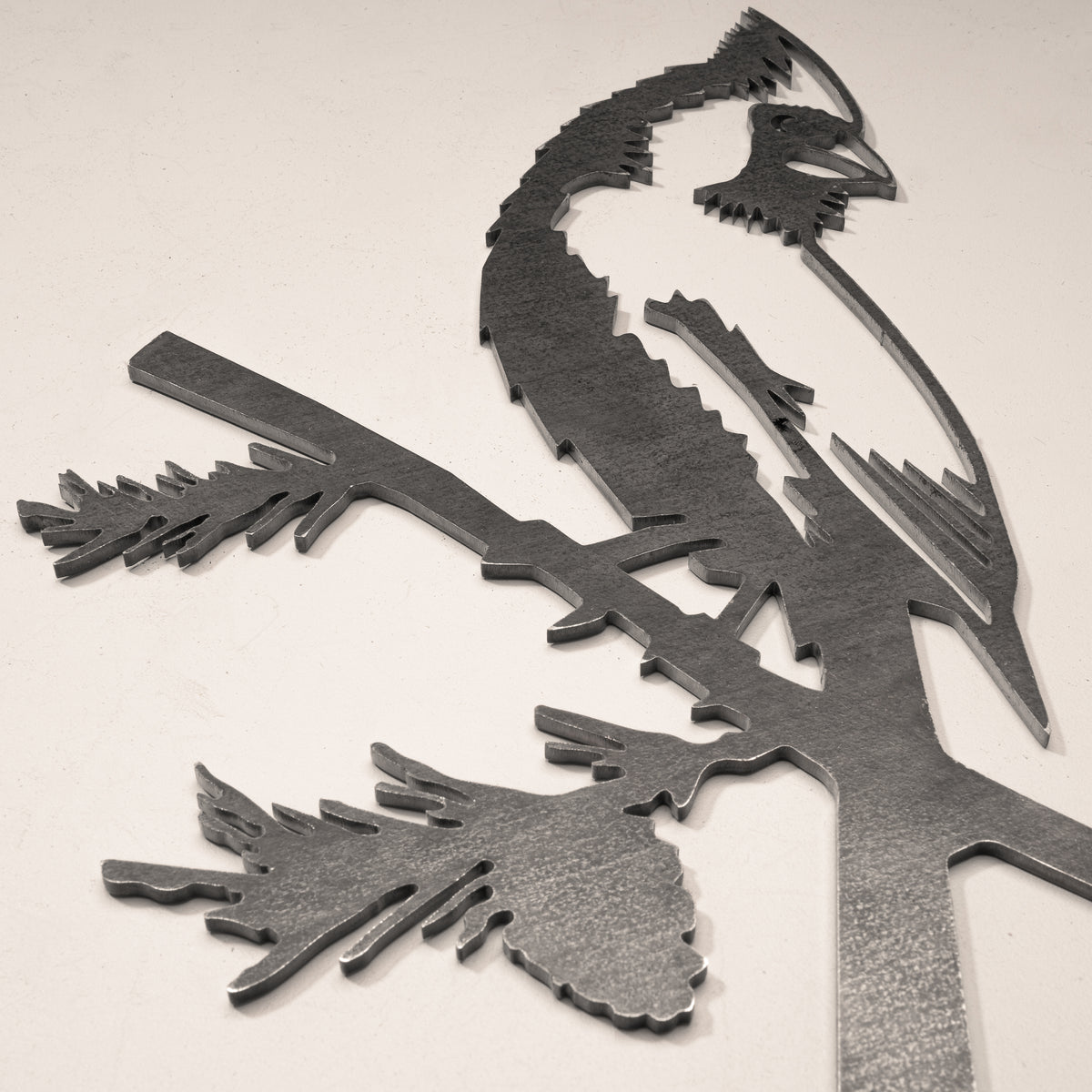 Close-up of the Cardinal cut-steel silhouette and surface detail.