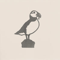 The Puffin by Metalbird Canada is a metal silhouette of a puffin standing on a rock, perfect as unique garden art or a thoughtful gift for nature lovers.