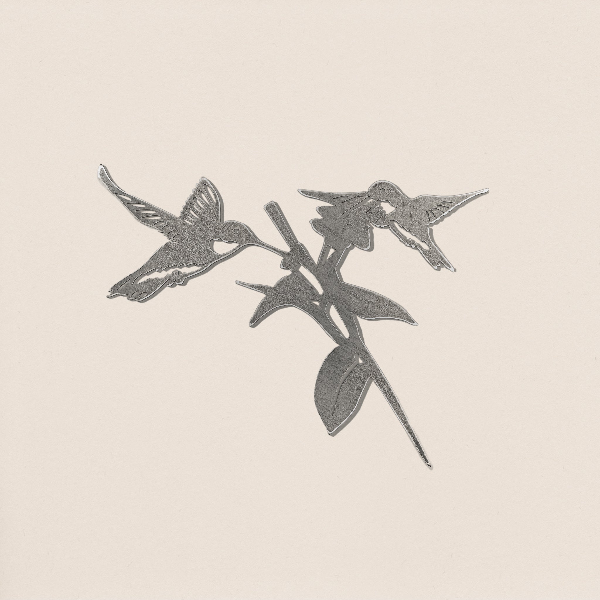 Hummingbird Honeys by Metalbird Canada features a black and white illustration of two hummingbirds around a flower, set on a plain light background—ideal as garden art or a unique gift.