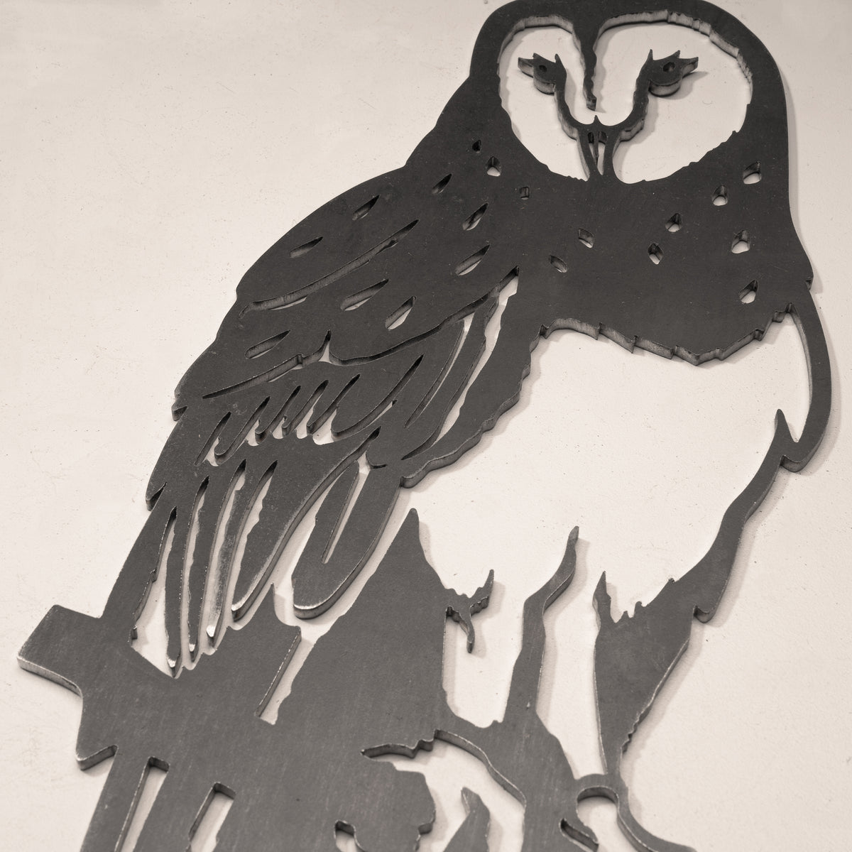 Close-up of the Barn Owl steel silhouette with a heart-shaped face.