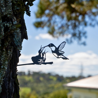 The Metalbird Canada Hummingbird & Chicks silhouette features two hummingbirds perched together—one feeding the other. This limited edition is a perfect Mother's Day gift for bird lovers.