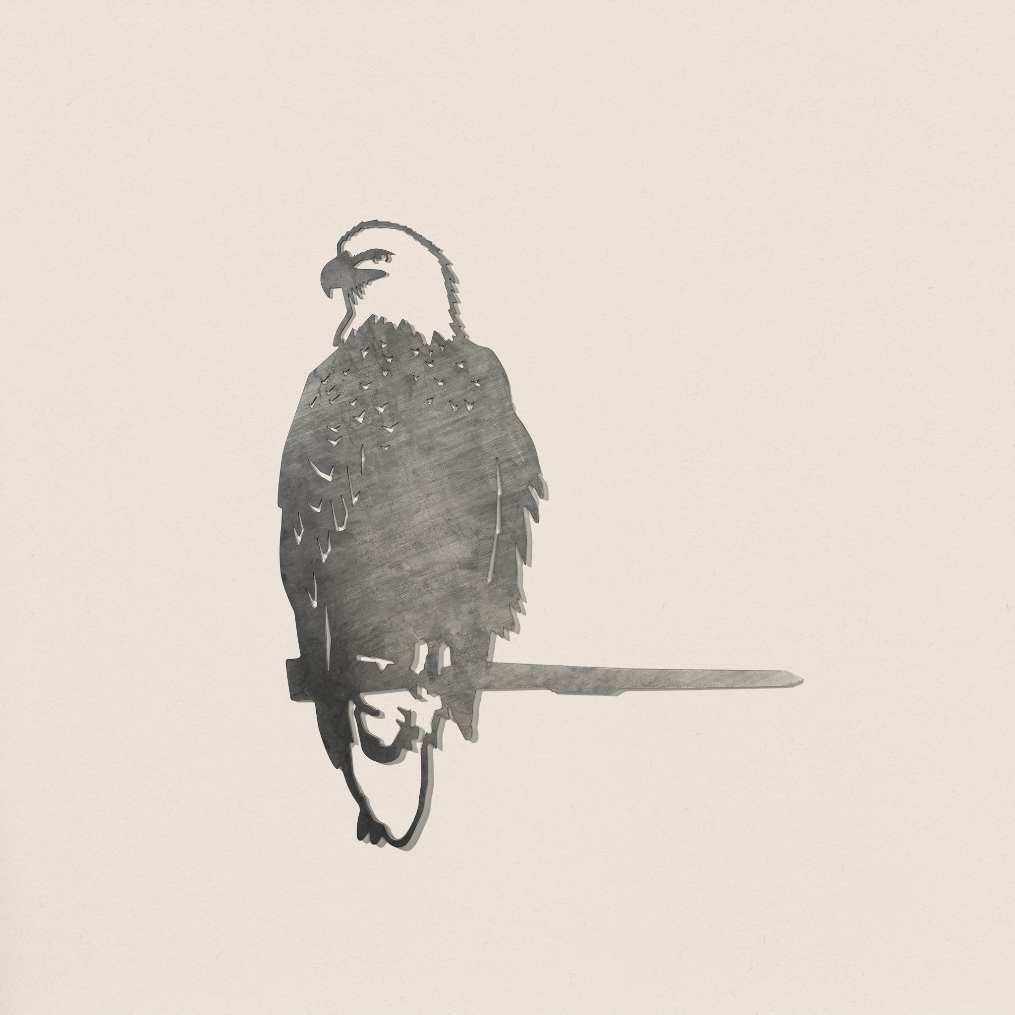 A minimalist, monochrome sketch of a Bald Eagle perched on a branch by Metalbird Canada, set against a light background—ideal as inspiration for corten steel yard art or a distinctive gift.