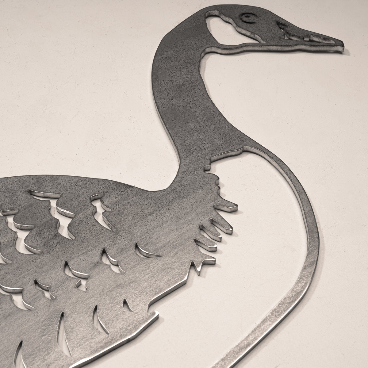 Close-up of the Canada Goose silhouette cut from unpainted steel.