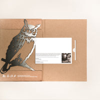 The Great Horned Owl folder by Metalbird Canada features a brown cover with a metal owl cutout on the left and a slotted white card with text and a black-and-white portrait on the right. Embossed writing at the bottom adds a unique gift touch.