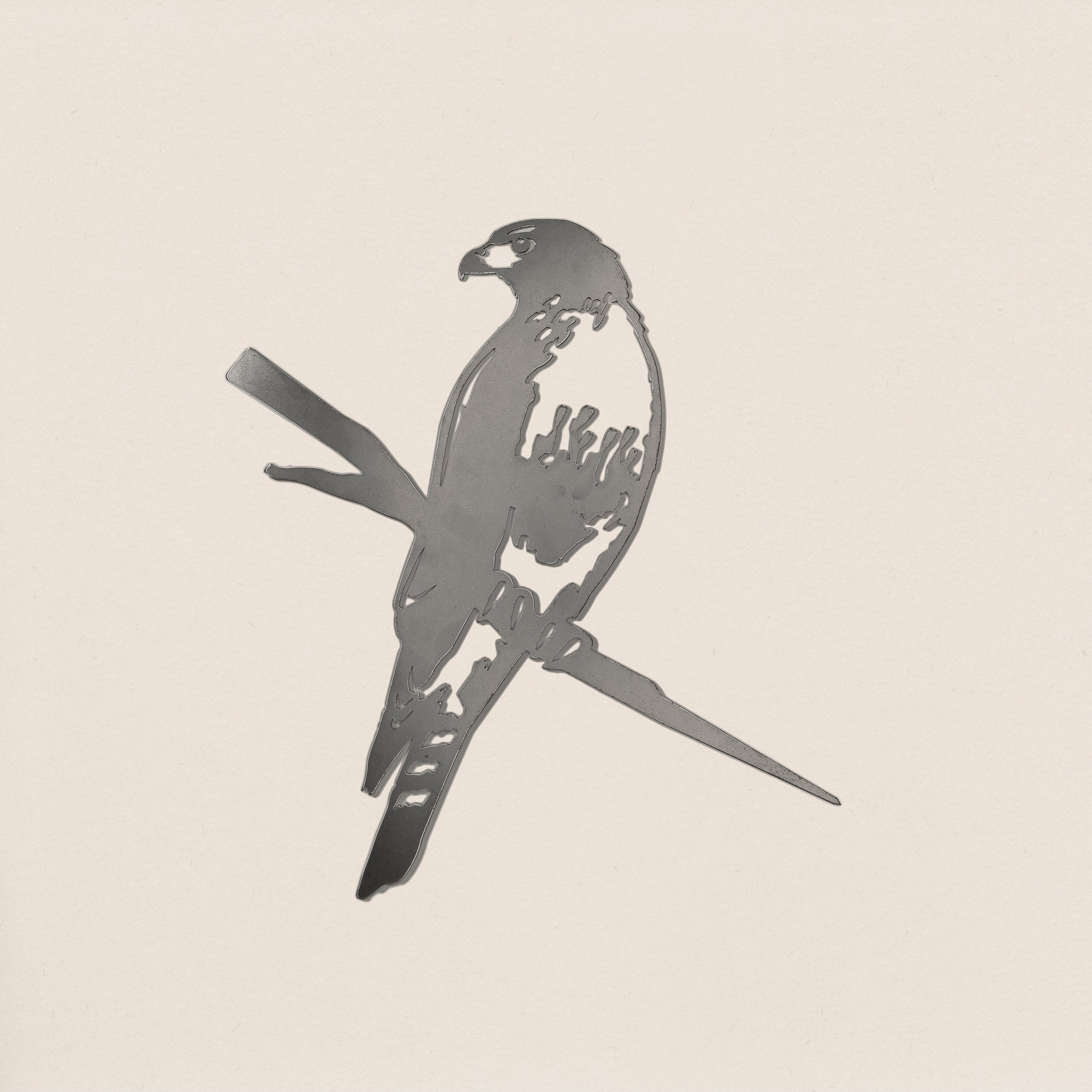 The Red-Tailed Hawk by Metalbird Canada is a corten steel silhouette of a hawk with folded wings, perfect for eye-catching yard art or as a unique gift, shown here against a light background.