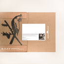 The Cardinal by Metalbird Canada features a brown cardboard folder with a bird-on-branch cutout on the left and a white card with text and a black-and-white photo on the right, partially tucked into a slot.