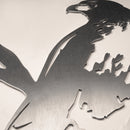 A close-up of the Metalbird Canada Red-Tailed Hawk cutout, featuring a brushed metal finish on a light surface. This sleek, modern yard art makes a unique gift for bird lovers.