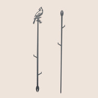 The Metalbird Canada Cardinal Plant Stake - 40" is a black corten steel garden stake featuring a cardinal cutout atop a branch and pointed end for easy placement—an ideal, unique garden gift.