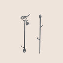 The Chickadee Plant Stake - 25" by Metalbird Canada features a striking black metal silhouette of a bird with berries, adding distinctive garden art to any space. Displayed on a plain, light background, it's the perfect accent for your outdoor decor.