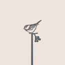 The Chickadee Plant Stake - 25" by Metalbird Canada features a minimalist corten steel silhouette of a small bird on a branch—an eye-catching and unique gift for any garden or home.
