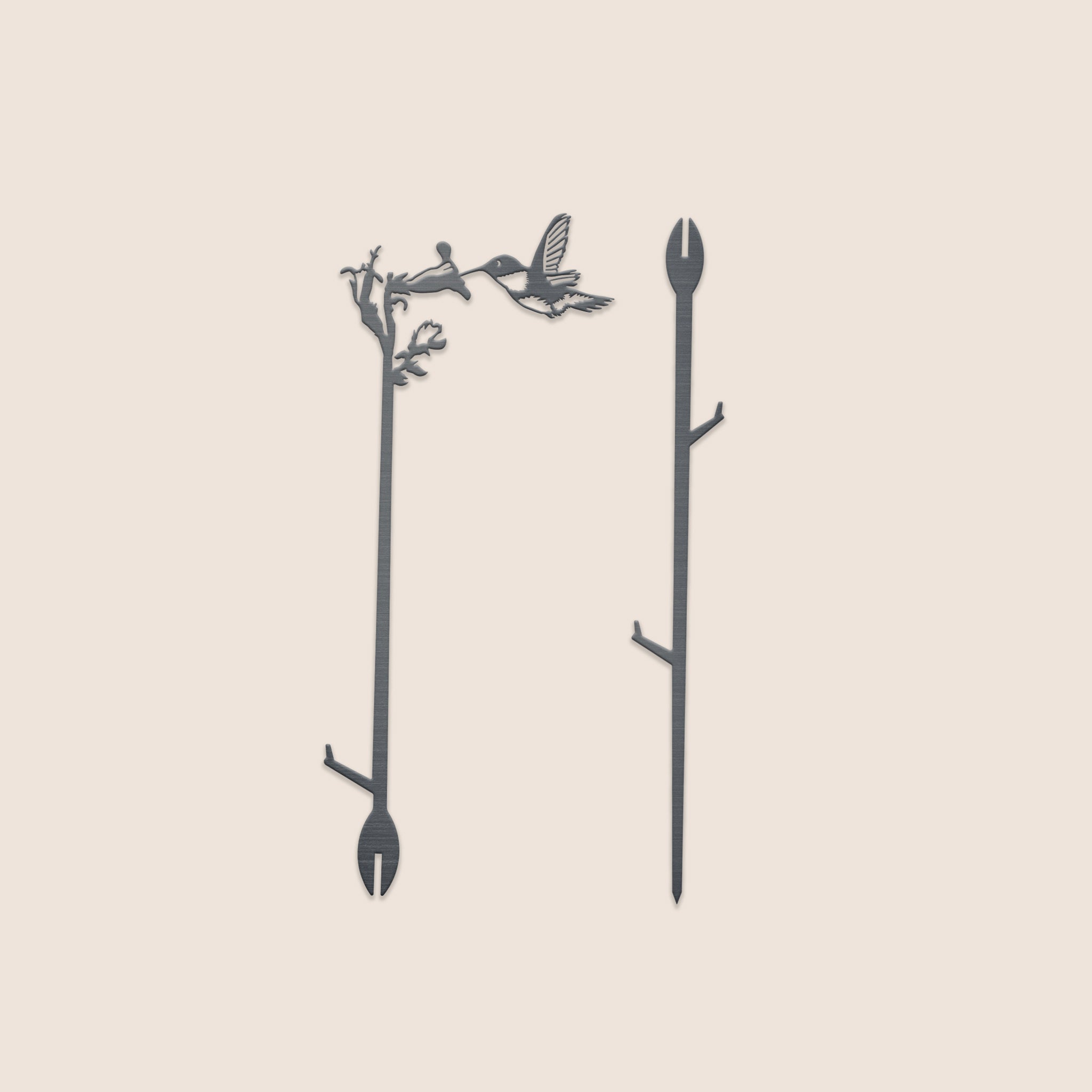 Set of two slender Metalbird Canada plant stakes (25"): one features a hummingbird and branch silhouette, the other has small branch details. Both have forked ends for stability.