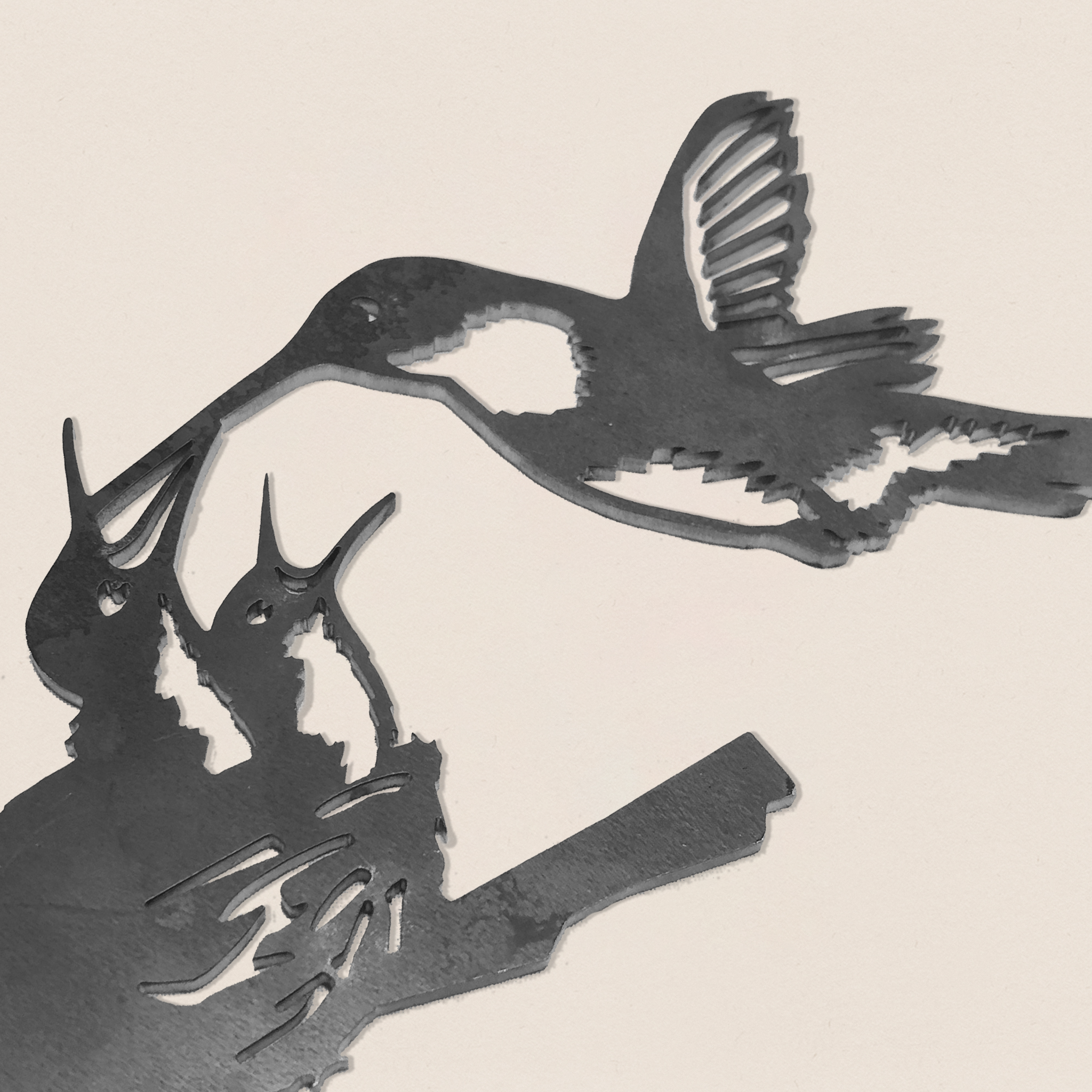 The Hummingbird & Chicks by Metalbird Canada features a cutout of a mother feeding her chicks, making it an intricate and heartfelt Mother's Day gift.